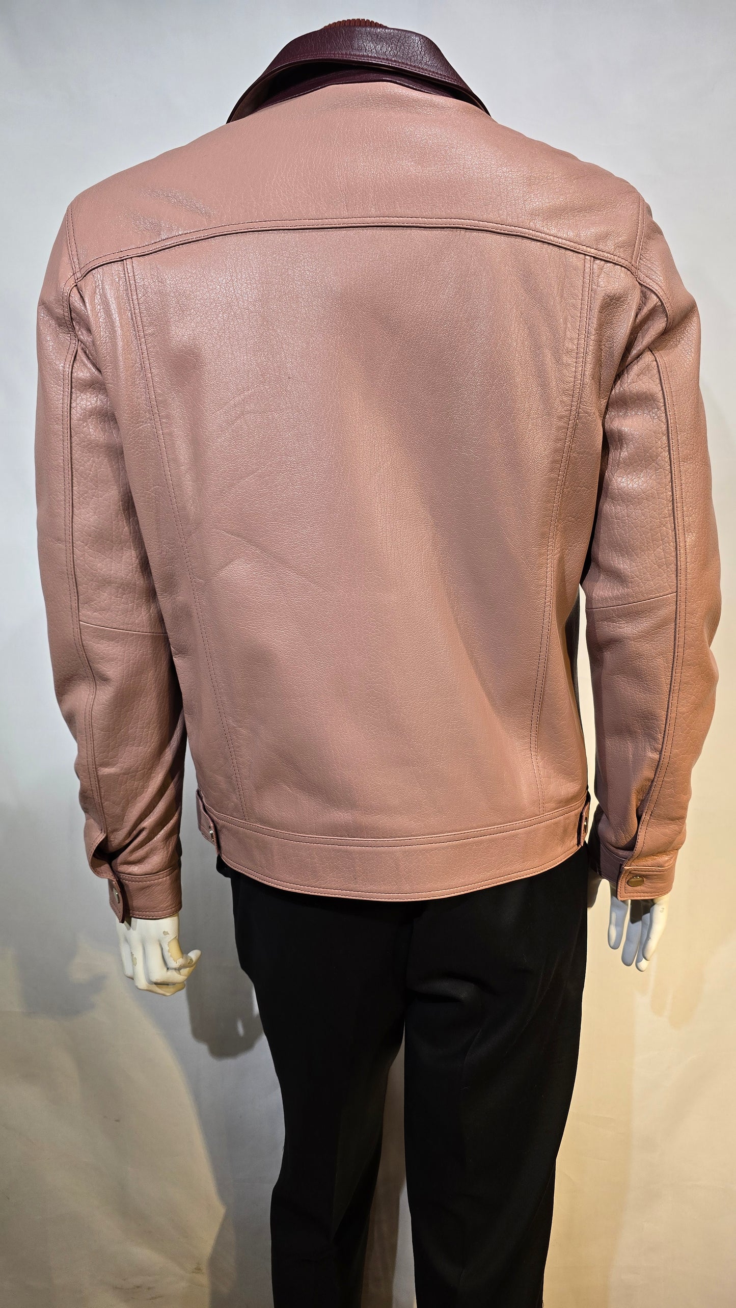 Fine lambskin leather with contrasting collar. Salmon color with 2 front chest snap pockets.