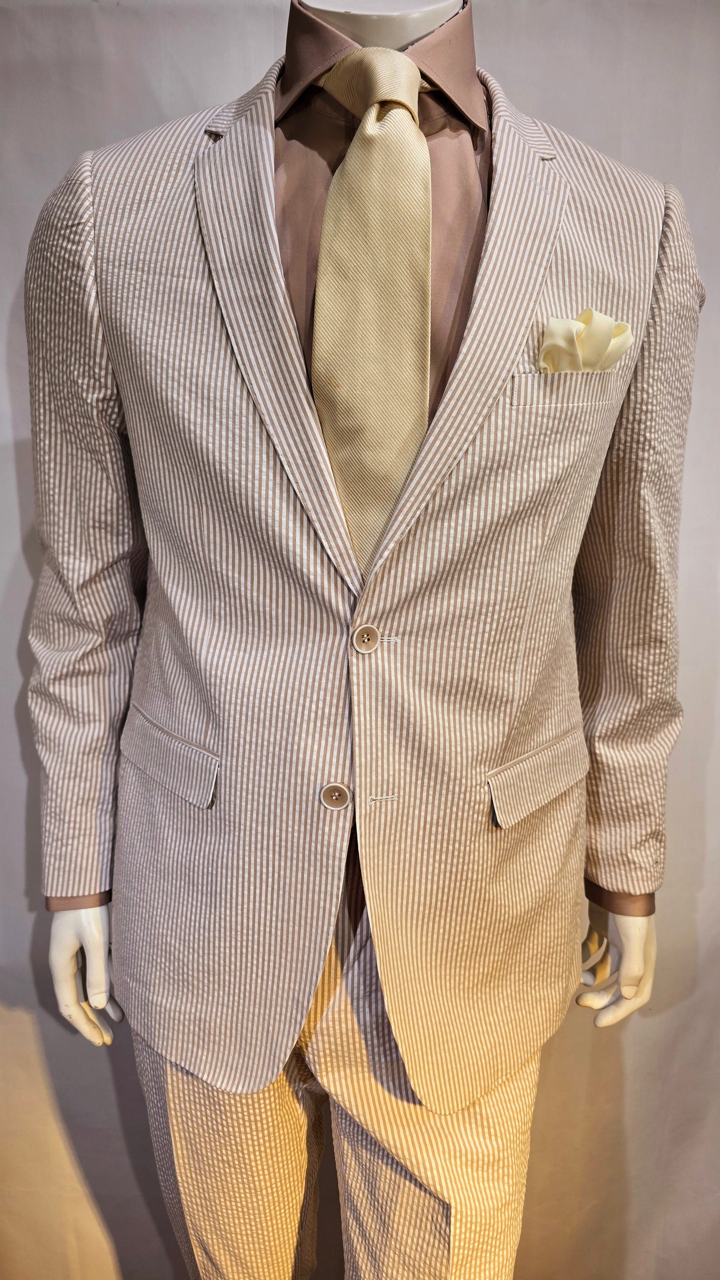 Summer ready. Fashionable, comfortable classic 2 button seersucker suit. Available in Banana yellow, soft pink, classic blue & classic Tan. Great for Summer weddings, outdoor events and summer cruises.